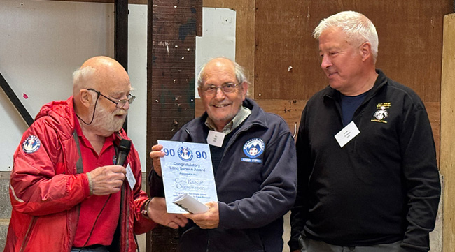 Bill Whitehouse (left) presenting Ben Lyon and Martin College (right) with a 90 year certificate