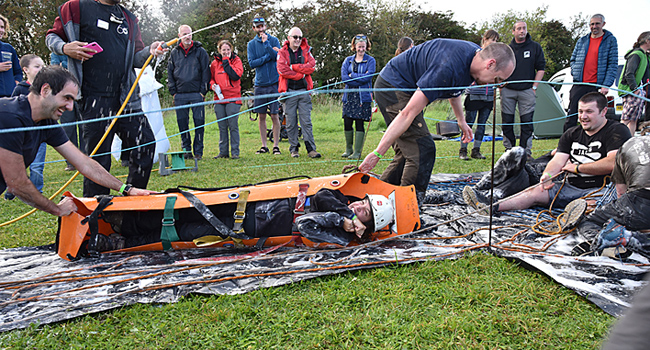 MCRO team members pulling the casualty through the final obstacle (cargo net) during the 'Wessex Challenge'