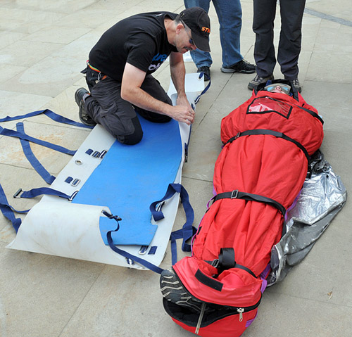 Casualty in a 'CasBag' about to be loaded into the stretcher