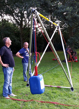 Team members experimenting with the rigging using a 'dummy' load.