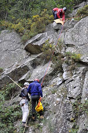 The rescuer reaching the crag-fast casualty