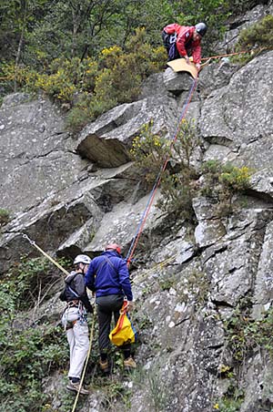 The rescuer reaching the crag-fast casualty