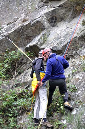 Putting the casualty into the triangular rescue harness
