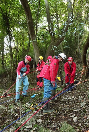 MCRO members hauling ropes to evacuate casualties stuck in a car in a 'sinkhole'.