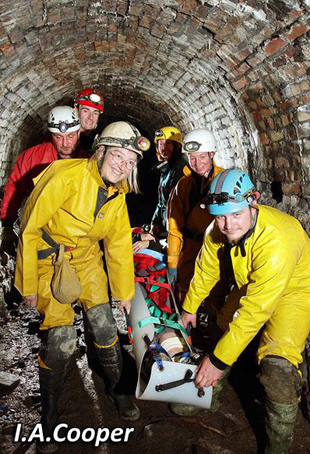 Carrying the casualty and stretcher back to the surface.