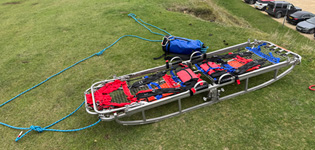 A SARA Bell stretcher ready for lowering down a steep slope to reach the casualty