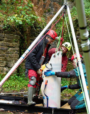 The casualty and stretcher being lifted from the shaft The stretcher reaching the surface